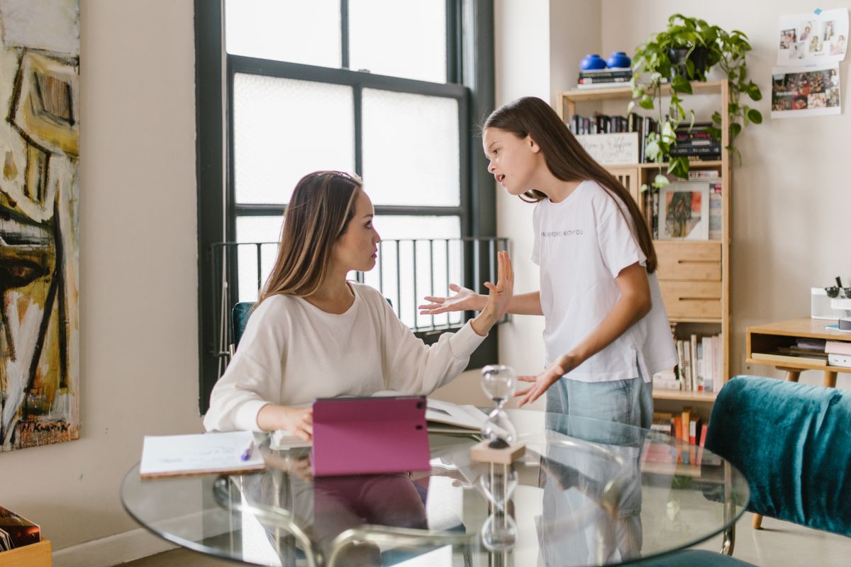 Child arguing heatedly with a parent at home